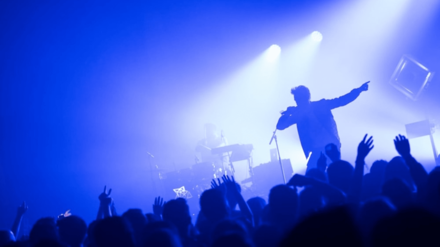 Concert crowd under blue stage lights at the Winter Gardens